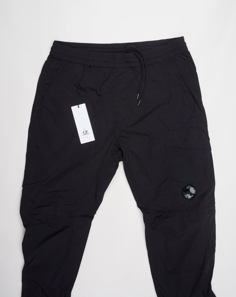 Multifilament fabric in Recycled nylon yarn Regular fit Drawstring waist Cuffed leg opening Single cargo pocket on left Leg Lens detail Garment dyed Article: 15CMPA247A005904G Color: Black / 999