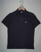 Regular fit polo shirt cut in a short sleeve construction with a two button placket, a classic collar, and the C.P. Company logo on the chest. Made in a fine 24/1 cotton pique, and resist dyed for a varied, tonal finish. Art. PL094A5263W 005263W Col. 888 Total Eclipse Classic collar Two button placket Logo detail Short sleeves Resist dyed Regular fit 