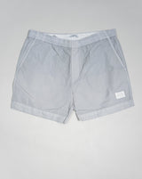 Eco-Chrome swim shorts constructed with an elasticated drawstring waist, hand pockets and a logo detail. Chrome is C.P. Company’s foundation woven multifilament nylon. This new version uses Econyl® regenerated nylon yarns, created through the upcycling of fishing nets.  Art.  BW005A 6369G Col.  936 Light Gray Elasticated drawstring waist Hand pockets Logo detail Nylon dyed 