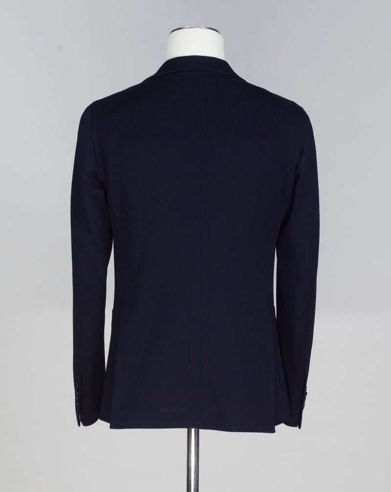 Composition: 75% Cotton 25% Virgin Wool Modello: Monte Carlo / 1SMJ22K Color: Navy / B1040 Unconstructed Unlined 2 Buttons Notch lapel Patch pockets Side vents Made in Martina Franca, Italy Tagliatore Textured Cotton & Wool Jersey Jacket / Navy