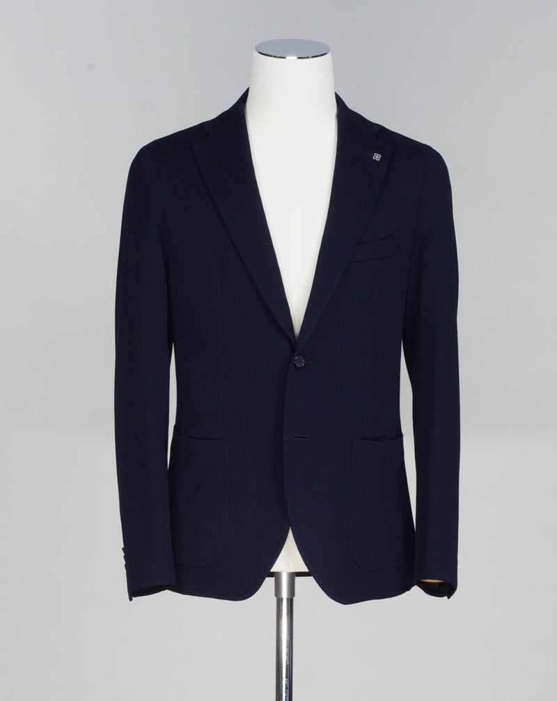 Composition: 75% Cotton 25% Virgin Wool Modello: Monte Carlo / 1SMJ22K Color: Navy / B1040 Unconstructed Unlined 2 Buttons Notch lapel Patch pockets Side vents Made in Martina Franca, Italy Tagliatore Textured Cotton & Wool Jersey Jacket / Navy