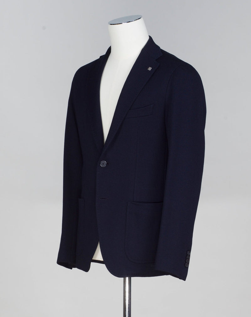 Composition: 75% Cotton 25% Virgin Wool Modello: Monte Carlo / 1SMJ22K Color: Navy / B1040 Unconstructed Unlined 2 Buttons Notch lapel Patch pockets Side vents Made in Martina Franca, Italy Tagliatore Textured Cotton & Wool Jersey Jacket / Navy