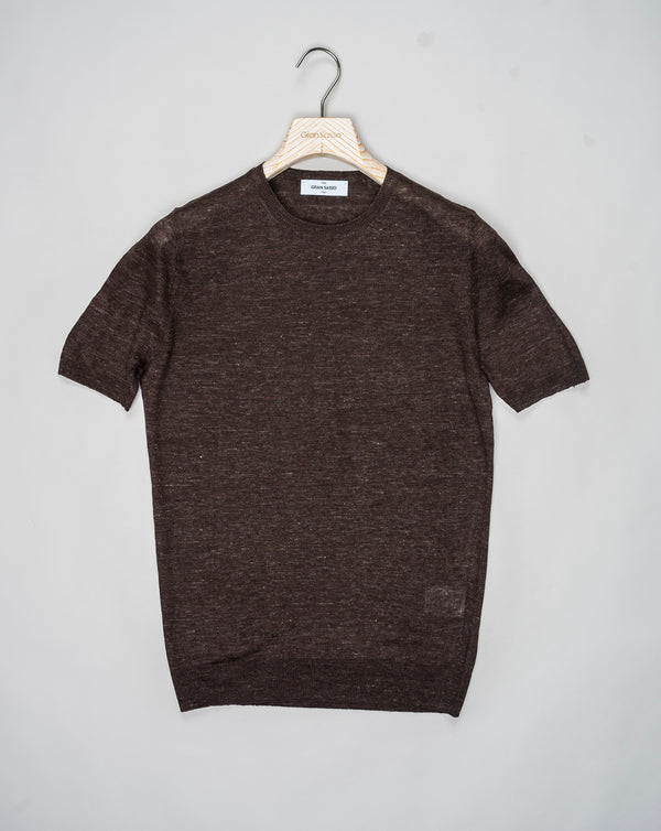 Indulge in luxury with Gran Sasso Knitted Linen T-Shirt. Made from high-quality knitted linen, this t-shirt offers a comfortable yet sophisticated fit. The perfect addition to your wardrobe for a touch of elegance and style.<ul> <li>Composition: 100% Linen</li> <li>Color: 175 / Dark Brown</li> <li>Article: 57177 / 24801</li> <li>Made in Italy</li> </ul>