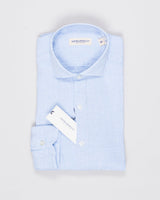 Cutaway collar
Curved hem

100% linen
Art. H9105
Mod. L69
Collar B878
Color: 01 Light Blue