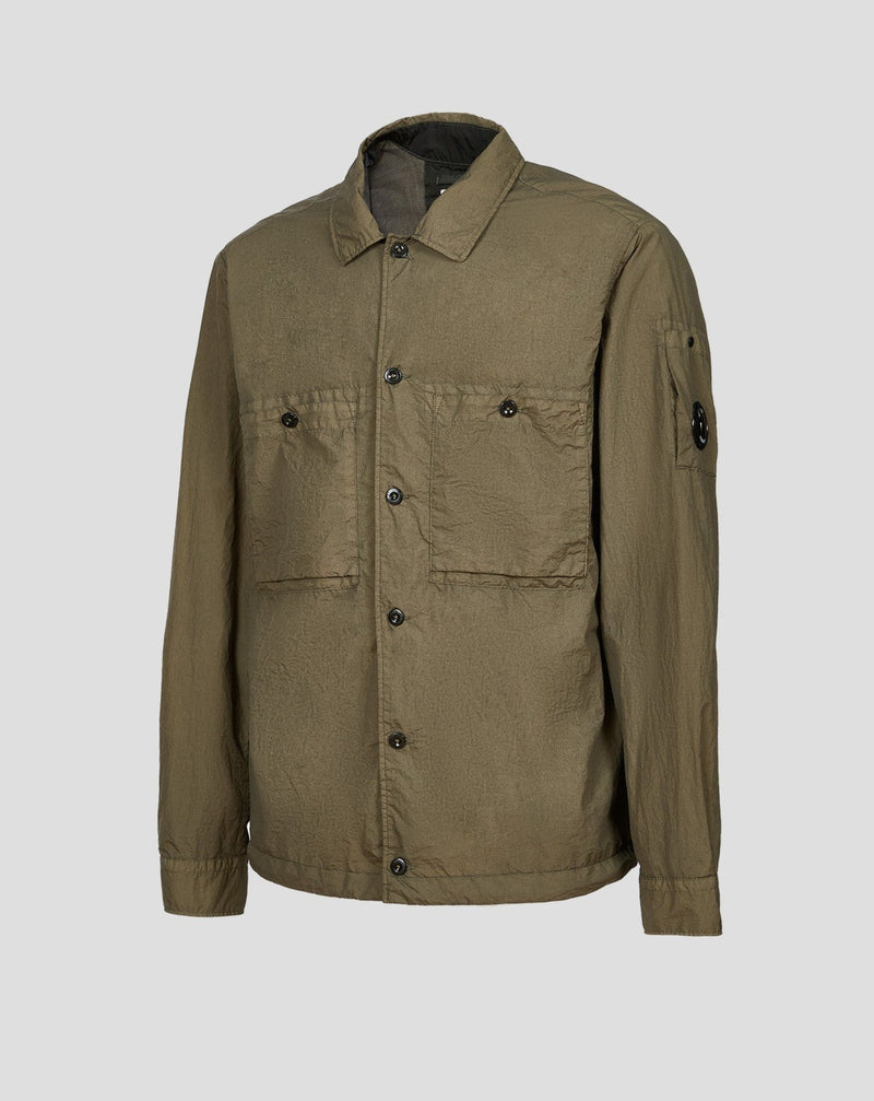 C.P. Company shirt crafted in Taylon L, a 100% nylon fabric that's water-resistant and quick to dry. The complete piece is garment dyed, for an increased chromatic depth and intensity throughout. Art. 13CMSH194A 005783G Col. 669 / Thyme Green C.P. Company Lens on left sleeve