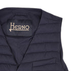 Herno In-Tech™ Alternative Down Waistcoat in Blue. Great piece for layering.A true must have for every modern gentleman.  Wear it under jacket or over a knit. Great for traveling as it packs small and weighs almost nothing.   In-Tech™ Alternative Down Water Repellent  Breathable Light Insulation 5 buttons  3 pockets  Adjustable back External layer 100% Polyamide Internal padding 100% Polyester  PC0039U 19288 9201 Made in Romania