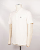C.P. Company polo shirt in a short sleeve construction, featuring a two button placket, a classic collar, and the C.P. Company logo at the chest.  CP COMPANY Polo Short Sleeve MPL067A005263W Col. 103 Gauze White Composition: 100% cotton Classic Collar Two Button Placket Short Sleeves Embroidered Logo at Chest