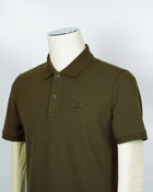 C.P. Company polo shirt in a short sleeve construction, featuring a two button placket, a classic collar, and the C.P. Company logo at the chest.  CP COMPANY Polo Short Sleeve MPL067A005263W Col. 683 Ivy Green Composition: 100% cotton Classic Collar Two Button Placket Short Sleeves Embroidered Logo at Chest