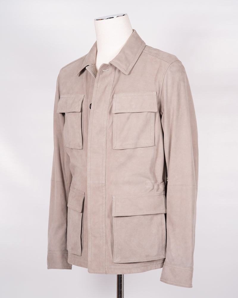 Light field jacket made of soft goatskin suede and napped inside. Four flap pockets in front and adjustable draw string on the waist. Super soft leather and light tone in color together make a truly luxurious interpretation of a field jacket.  100% goatskin suede, napped inside Body: unlined, sleeve lining: 100% polyamide Metal buttons with embossed logo Four large flap pocket Inside pockets Mod: 91 1501 ZN 484 Werner Christ