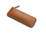 A sleek and elegant storage option for your pencils and small creative items. Useful for keeping your desk space neat and tidy, as well as for keeping your creative tools organized while on-the-go. Tuck this little pouch into your favoured travel or commuter bag to keep all of your writing utensils neatly assembled. Measurements: L: 22  H: 8,5 W: 0,5 (cm) Body: Vegetable tanned full-grain cow leather Leather trimmings: Vegetable tanned full-grain cow leather Lining: Cotton/nylon stripe lining in off white/a
