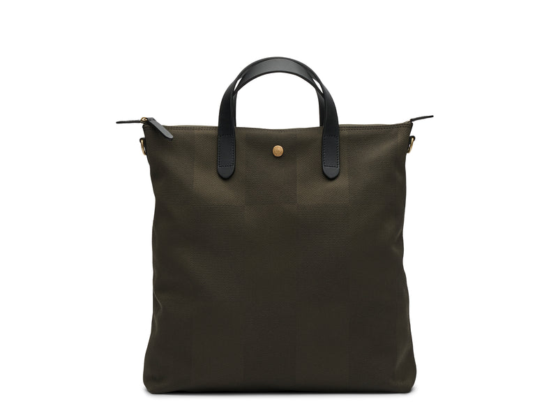 Measurements:  L: 37 x H: 41 x W: 10 cm Fabric composition:PA 12% CO 40% PL 48% - 810 gr/rm Body: Jacquard woven cotton canvas Trimmings:  Black, Vegetable tanned full-grain bridle leather  Lining: 100% cotton in army colour Hardware: Solid brass with varnish protection  Zipper: Hand polished YKK Excella As the first style ever launched in the Contemporary collection, the M/S Shopper has grown to become one of the most iconic styles of the Mismo 