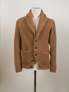 Drake's shawl collar cardigan made up in a soft lambswool. Wear it as an alternative to your tailored jacket on more casual days, or thrown over just about anything: its beauty is its versatility. 100% Lambswool Brown Knotted Leather Buttons Color: Camel KNI-64LAM-20818-002 Made in Scotland