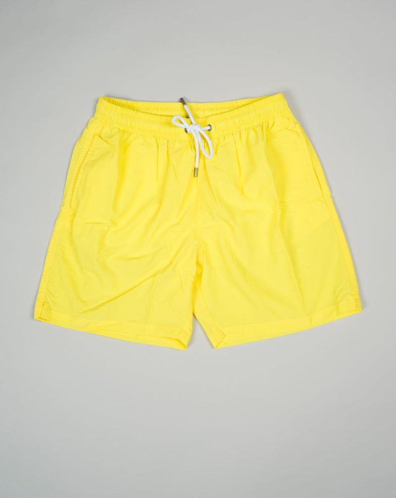 Basic swim trunks with adjustable drawstring waistband. Slim fit Fits true to the size. If in doubt of your size, please contact us HERE 100% Polyamide Color: Yellow Drawstring Two side pockets and one back pocket Made in Portugal