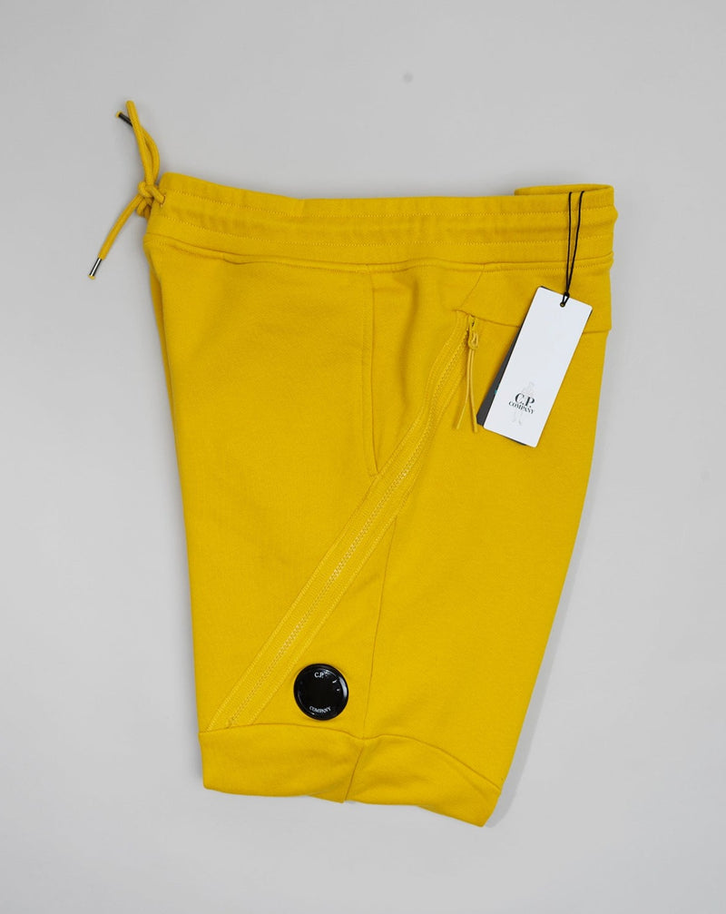 C.P. Company's diagonal raised fleece is a mid-weight option that's woven from a soft loopback cotton, for premium comfort with a durable, rugged feel.  Side slip pockets Lens detail Cargo Pocket on left side Tapered fit Adjustable drawstring waist Art. 12CMSP084A 005086W Col 239 / Nugget Gold / Yellow 100% cotton