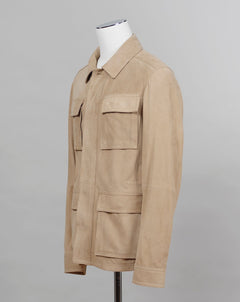 Light field jacket made of soft goatskin suede and napped inside. Four flap pockets in front and adjustable draw string on the waist. Super soft leather and light tone in color together make a truly luxurious interpretation of a field jacket.  100% goatskin suede, napped inside Body: unlined, sleeve lining: 100% polyamide Metal buttons with embossed logo Four large flap pocket Inside pockets Mod: 91 1501 ZN 222