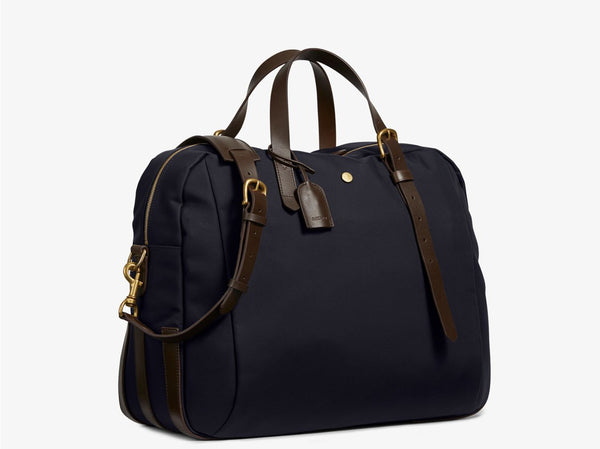 Measurements:   L: 47  H: 42  W: 31 (12) cm Body: Waterproof hard woven Italian nylon  Fabric composition: PA 42%  CO 38%  PU 20%   /   826 g/m Trimmings: Dark brown custom developed vegetable tanned full-grain bridle leather Lining: 100% cotton in navy colour  Hardware: Solid brass with varnish protection  Zipper: Hand polished YKK Excella The perfect holdall for the active lifestyle. The M/S Something easily does the job for any trip 