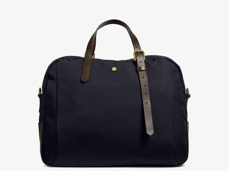 Measurements: L: 47 H: 42 W: 31 (12) cm Body: Waterproof hard woven Italian nylon Fabric composition: PA 42% CO 38% PU 20% / 826 g/m Trimmings: Dark brown custom developed vegetable tanned full-grain bridle leather Lining: 100% cotton in navy colour Hardware: Solid brass with varnish protection Zipper: Hand polished YKK Excella The perfect holdall for the active lifestyle. The M/S Something easily does the job for any trip