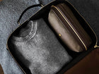 Measurements: L: 46 H: 35 W: 15 cm Material: Tight-woven cotton canvas Composition: CO 94% PU 4% PC 2% / 709 g/m Trimmings: Dark brown, vegetable tanned full-grain bridle leather The M/S Suitcase fuses the contours of heritage travel bags with a minimalist design approach, equipping the carrier with a spacious and aesthetically pleasing bag. A sharp and clean-cut 48-hour suitcase