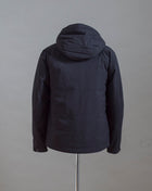 C.P. Company Pro-Tek Hooded Jacket that combines the weight and comfort of a sweatshirt with the protective functions of an outer layer. Water resistant coating on the upper layer of the jacket. Art. 13CMOW025A 004117A Col. 999 / Black Zippered pocket  Pocket with C.P. Company Lens on the left arm Adjustable hood and hem Water resistant