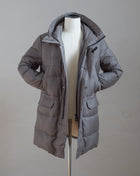 Montecore Down Coat made of Loro Piana Rain System® cloth. The Rain System® treatment makes fabrics water and any liquid repellent and therefore it prevents dust, dirt, and liquid stains from damaging the fabric. Art. F03MUCX501F Col. 96 / Taupe Loro Piana Rain System® Treated Fabric Outer Fabric 95% Virgin Wool 5% Silk 90% Down 10% Feather filling Removable hooded bib. Adjustable Waist