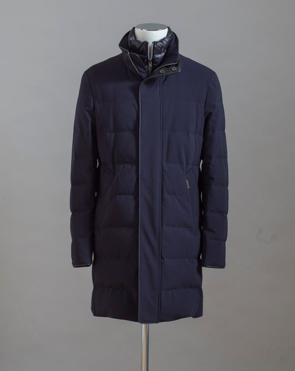 Montecore Full Length Down Coat. Removable bib. Slanted side pockets to slip your hands into when the weather gets rough.  Art. F03MUCX584 Col. 106 / Navy 90% Down 10% Feathers Outer: 91%Pl 9%Pu Removable bib