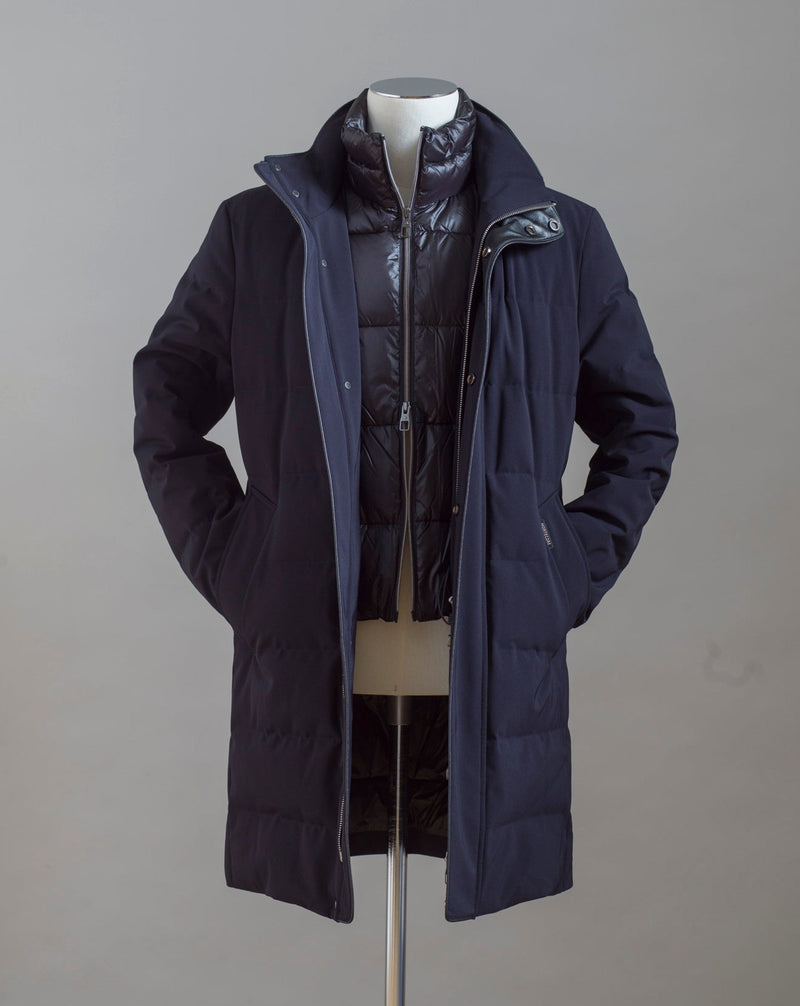 Montecore Full Length Down Coat. Removable bib. Slanted side pockets to slip your hands into when the weather gets rough.  Art. F03MUCX584 Col. 106 / Navy 90% Down 10% Feathers Outer: 91%Pl 9%Pu Removable bib