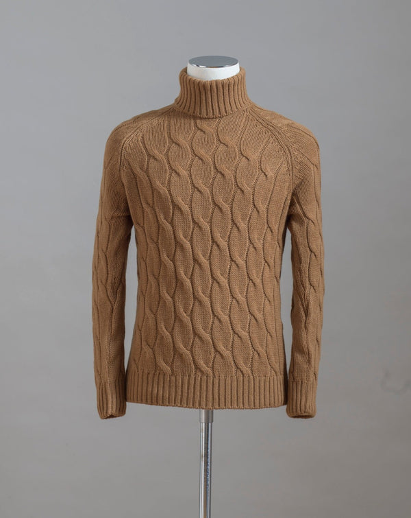 Gran Sasso cable knit roll neck made of special 3-ply Air Wool quality. The special feature of this garment is the yarn that holds microscopic air bubbles between the fibers, making it at the same time warm and light.  Art.  13117/22622 Col.  117 / Tobacco 100% Wool Made in Italy 