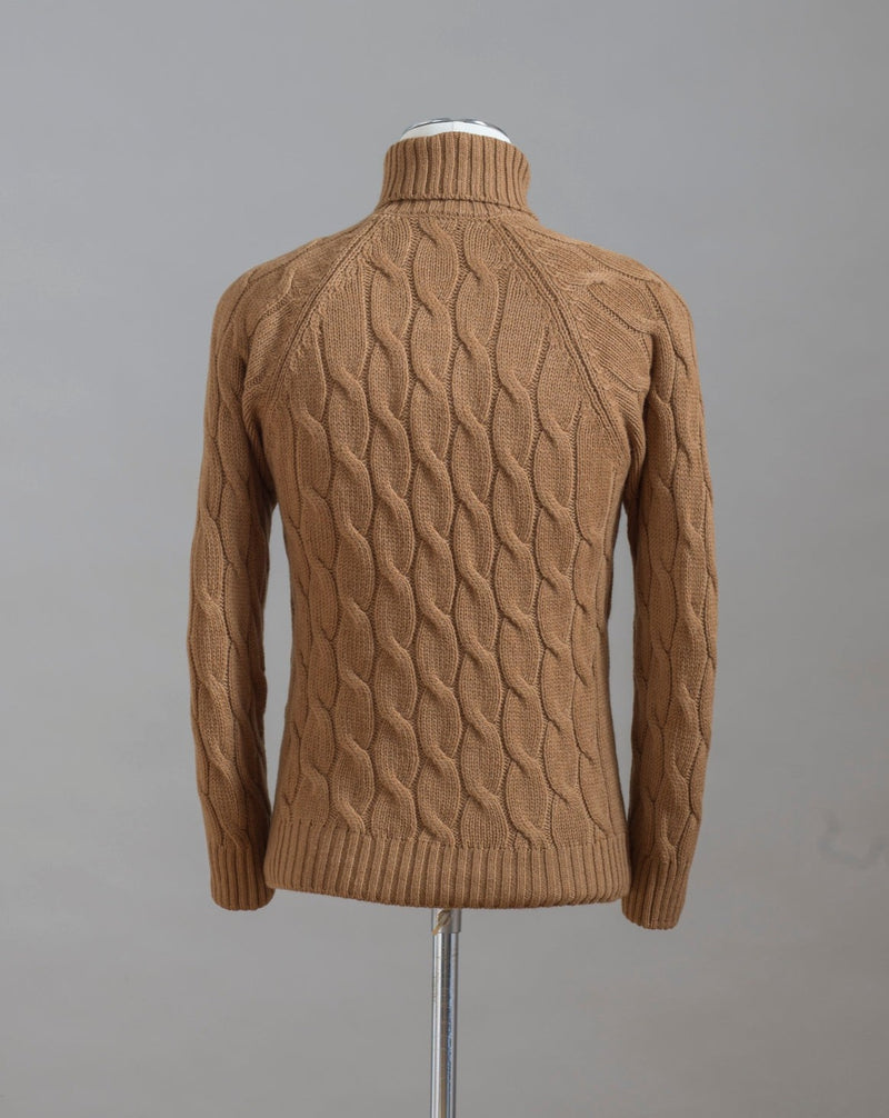 Gran Sasso cable knit roll neck made of special 3-ply Air Wool quality. The special feature of this garment is the yarn that holds microscopic air bubbles between the fibers, making it at the same time warm and light.  Art.  13117/22622 Col.  117 / Tobacco 100% Wool Made in Italy 