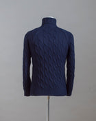 Gran Sasso cable knit roll neck made of special 3-ply Air Wool quality. The special feature of this garment is the yarn that holds microscopic air bubbles between the fibers, making it at the same time warm and light.  Art.  13117/22622 Col. 598 Navy 100% Wool Made in Italy 