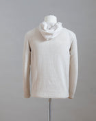  Hooded stitch sweater in Super Geelong wool. A sporty garment that you can match with jeans for an urban look or with jogging-style trousers for a sporty and refined outfit. Geelong wool has as soft touch as cashmere, yet it is remarkably durable. One of the best wool qualities you can find.  Hooded Sweater 100% Wool  Ribbed hem and cuffs Article:  24171/25024 Colore: 054 / Panna Made in Italy