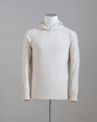 Hooded stitch sweater in Super Geelong wool. A sporty garment that you can match with jeans for an urban look or with jogging-style trousers for a sporty and refined outfit. Geelong wool has as soft touch as cashmere, yet it is remarkably durable. One of the best wool qualities you can find.  Hooded Sweater 100% Wool  Ribbed hem and cuffs Article:  24171/25024 Colore: 054 / Panna Made in Italy
