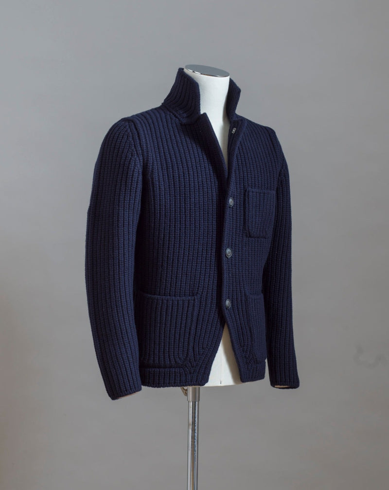 Heavy ribbed jacket made of 5-Ply Super Geelong wool. Geelong wool has as soft touch as cashmere, yet it is remarkably durable. Elegant, comfortable and practical wool quality, perfect for a chunky garment like this.  100% Geelong wool 3 Patch pockets 3 Buttons Mod.  10166/25028 Col. 598 / Navy Made i Italy