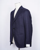 caruso full canvas Fully lined Unconstructed shoulder 3 roll 2 buttoning Side vents Notch lapel Patch pockets Composition: 100% wool Color: Blue melangé Modello: Aida / ASM2JM304F Article: 500382 Colore: 0150 Made in Italy