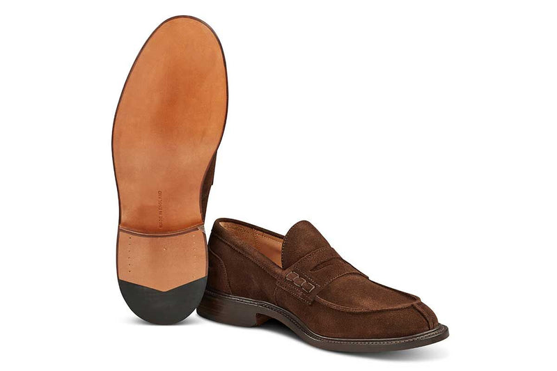 Tricker’s classic step in Penny loafer combines comfort with quiet confidence. In chocolate Repello suede with storm welt, leather uppers and linings for even greater refinement, channelled and stitched leather sole. Tricker's James Suede Penny Loafer / Chocolate