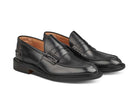 Tricker’s classic step in Penny loafer combines comfort with quiet confidence. In black calf with storm welt, leather uppers and linings for even greater refinement, channelled and stitched leather sole. Tricker's James Penny Loafer / Black