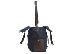 Measurements: L: 46 H: 34 W:18 cm Body: Waterproof hard woven Italian nylon Fabric Composition: PA 42% CO 38% PU 20% / 826g pr. meter Trimmings: Dark brown vegetable tanned full-grain bridle leather Lining: 100% cotton in Navy colour Hardware: Solid brass with varnish protection Zipper: Hand polished YKK Excella Art. No. MS111312 travel bag, or bend flaps down for a large, open city tote bag. A full-grain leather pocket on each gusset adds extra durability to the bottom corners