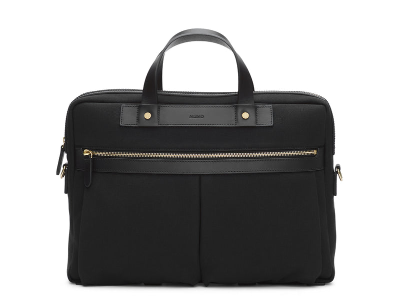 Measurements:  L: 39  H: 29  W: 8cm Body: Water-repellent cotton and nylon blended canvas Fabric composition:  PA 47% PL 20% CO 20% PC 6% PU 7%  /  812g/m  Trimmings: Black custom developed vegetable tanned full-grain bridle leather   Lining: 100% cotton in army colour  Hardware: Solid brass with varnish protection  Zipper: Hand polished YKK Excella Art. No. MS466418 A softer and more casual counterpart to the M/S Briefcase, the M/S Office is designed with dual front pockets that zip open 