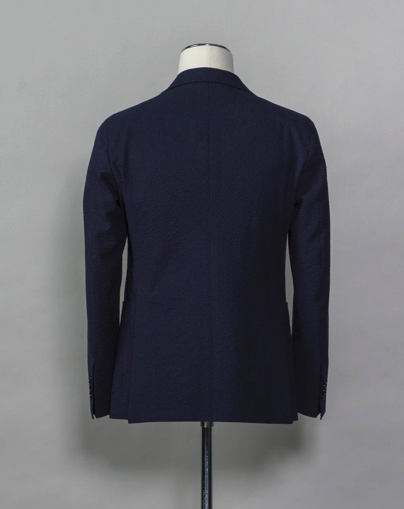 Tagliatore Seersucker summer suit.  Unlined jacket and unconstructed shoulders combined with this iconic summer fabric are guaranteed to keep you comfortable even on the hottest summer parties.  Composition: 96% Cotton 3% Elastan Bistretch 1% Polyamide (Nylon) Modello: 2SMC22K01 Color: Navy / B1185 Unconstructed Unlined 2 Buttons Notch lapel Patch pockets Side vents Flat front Belt loops Made in Martina Franca, Italy