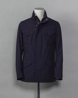 Montecore waterproof field jacket. Four pockets in front and adjustable waistband. Adjustable hood that can be folded inside the collar. So all the classical elements of a proper field jacket plus the added value of a waterproof and breathable technical  material. Four pockets in front Adjustable waist band Adjustable hood inside the collar Waterproof Breathable Taped seams  79% Polyester 21% Polyurethane Art. S04MUCT603 Col. 89 / Navy