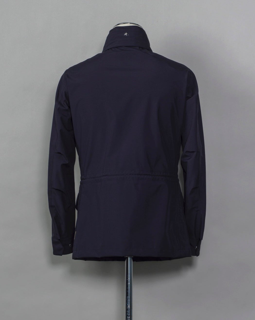 Montecore waterproof field jacket. Four pockets in front and adjustable waistband. Adjustable hood that can be folded inside the collar. So all the classical elements of a proper field jacket plus the added value of a waterproof and breathable technical  material. Four pockets in front Adjustable waist band Adjustable hood inside the collar Waterproof Breathable Taped seams  79% Polyester 21% Polyurethane Art. S04MUCT603 Col. 89 / Navy