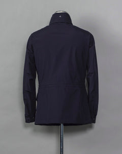 Montecore waterproof field jacket. Four pockets in front and adjustable waistband. Adjustable hood that can be folded inside the collar. So all the classical elements of a proper field jacket plus the added value of a waterproof and breathable technical  material. Four pockets in front Adjustable waist band Adjustable hood inside the collar Waterproof Breathable Taped seams  79% Polyester 21% Polyurethane Art. S04MUCT603 Col. 89 / Navy