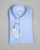 Light Blu striped long sleeved linen shirt from Ghirardelli. Washed to give the garment soft touch and relaxed look.  Composition: 100% Linen Color: Light Blue Long sleeves Removable collar bones
