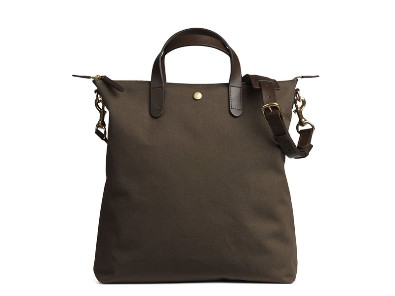 Measurements:  L: 37 x H: 41 x W: 10 cm Fabric composition: CO 94% PU 4% PC 2% - 709 gr/rm Body: Tight-woven cotton canvas Trimmings: Custom developed dark brown vegetable tanned full-grain bridle leather Lining: 100% cotton in army colour Hardware: Solid brass with varnish protection  Zipper: Hand polished YKK Excella Art. No. MS250112 As the first style ever launched in the Contemporary collection, the M/S Shopper has grown to become one of the most iconic styles of the Mismo